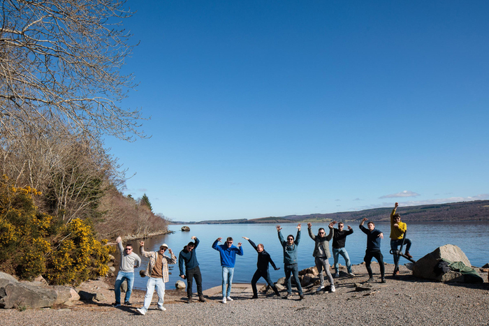 Team Webatvantage doet een imitatie van het monster van Loch Ness aan de oever van het beroemde meer